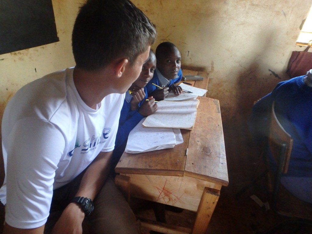 Luke helping some students during an English lesson